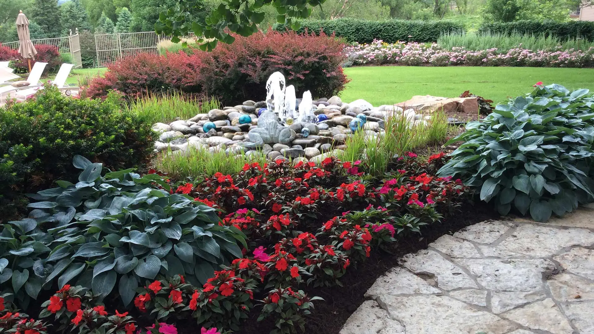 Custom water feature bubbling in a yard near Omaha, NE.