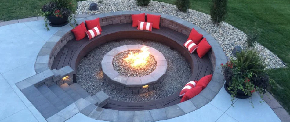 Lighting a fire pit with sitting wall near Elkhorn, Nebraska.