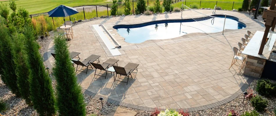 Landscaped backyard with pool and seating area in Ralston, NE.