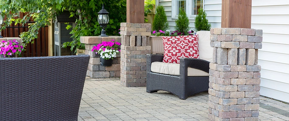 A custom outdoor living space installed behind a home in Elkhorn, NE. 