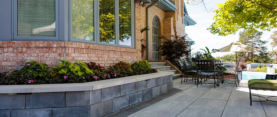 Outdoor steps, walk way, and retaining wall installed over patio in Omaha, NE.