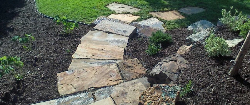Rock walkway installed between landscape beds in Papillion, NE.