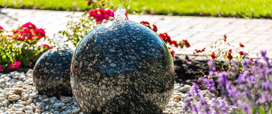 2 Round bubbling water features installed along a walkway in Omaha, NE. 