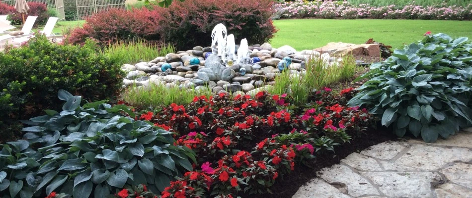 Water feature installed beside landscape bed in Ralston, NE.