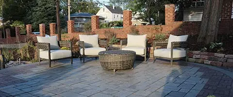 Custom patio with wicker chairs and ottoman in Waterloo, NE.